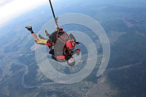 Skydiving. Tandem jump. Man and young woman are falling in the sky together.