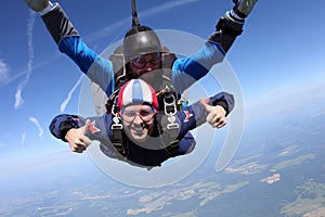 Tandem skydiving. Two guys are having fun in the sky.