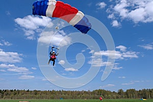 Tandem skydiving. Two happy men are landing.