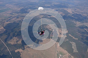 Tandem skydiving. Two happy men are landing.