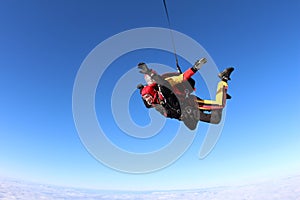 Tandem skydiving. Two men are in the sky.