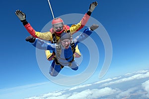 Tandem skydiving. Two strong men are in the sky.