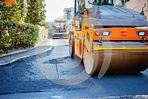 Tandem vibration roller compactor working on asphalt pavement