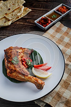 Tandoori Chicken. Indian barbecue chicken. Indian chicken dish prepared by roasting chicken marinated in yogurt and spices