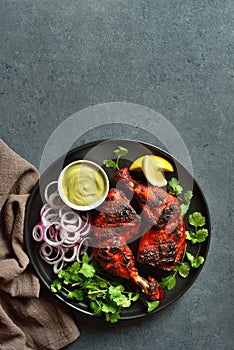 Tandoori chicken served with cilantro and onion