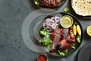 Tandoori chicken served with cilantro and onion