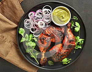 Tandoori chicken served with cilantro and onion