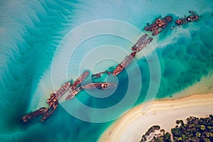 The Tangalooma Wrecks used to be 15 steam driven barges which were deliberately sunk in 1963 along the Moreton Island coastline to photo