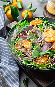 Tangerine and beet salad with arugula, walnuts and pine nuts