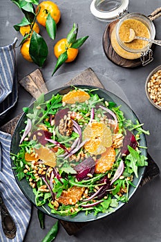 Tangerine and beet salad with arugula, walnuts and pine nuts