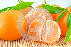 Tangerine or clementine with green leaf isolated