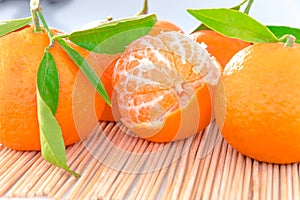 Tangerine or clementine with green leaf isolated photo