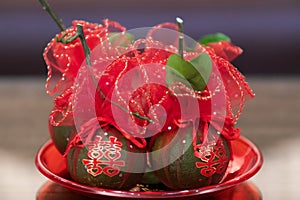 Tangerine Fruits in tray wrapped in red clothes, with Chinese Character stickers meaning Double Happiness, in Chinese Wedding