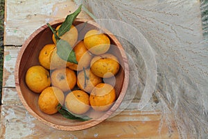 Tangerines or mandarin oranges in a wooden bowl photo