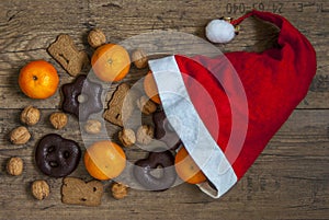 Tangerines, nuts, gingerbread and spiced biscuits fall out of a