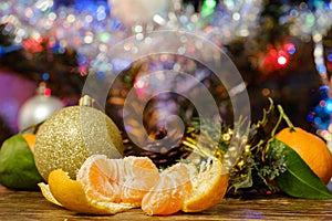 tangerines on the table against the background of the Christmas tree