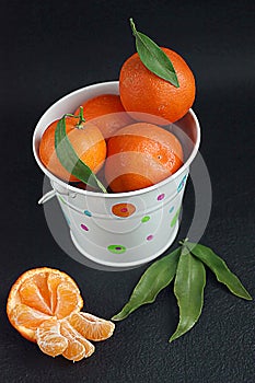 Tangerines in white bucket