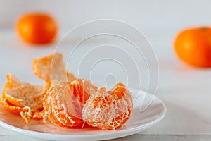 Tangerines in a white plate on a white background