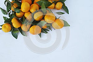 Tangerines on a white texture background. Christmas composition
