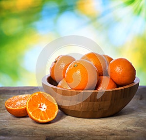 Tangerines in wooden bowl photo