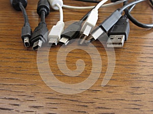 Tangle of dusty computer cables with sockets on the table