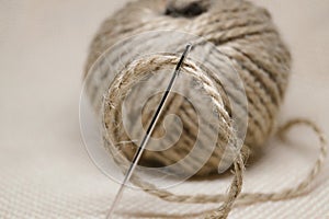 A tangle of thread rope with a large steel needle environmentally friendly material craft