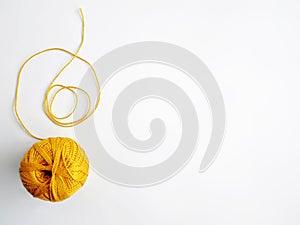 Tangle of yellow threads on a white background