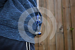 Tangled Earbuds in the pocket of a navy blue sweater