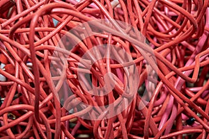 Tangled lump or pile of red electrical patch cords.