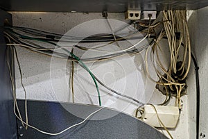 Tangled network cables and wires in server room