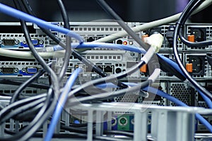 Tangled network cables and wires in server room for Unorganized