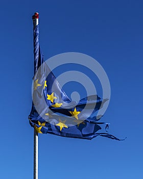 Tangled and ruptured European Union flag.