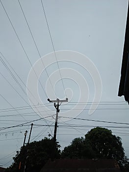 Tangled wires in a cloudy sky