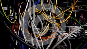 Tangled wires, power cables in datacenter, cabling mess in server room, closeup