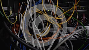 Tangled wires, power cables in datacenter, cleaning up server room cabling mess