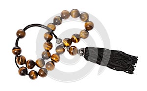 Tangled worry beads from tiger`s eye gems isolated