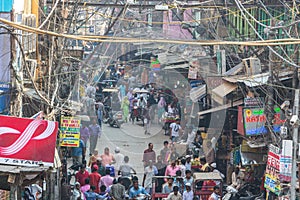 Tangles of utility wires above a busy street in the city of Delhi, India.