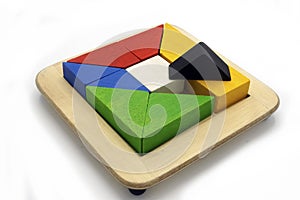 Tangram, Chinese traditional puzzle game made of different colorful wooden pieces that come together in a distinct shape
