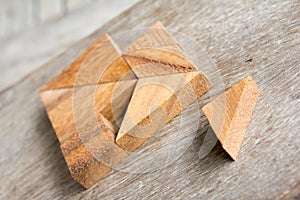 Tangram in heart shape wait for fulfill to complete on wooden ba