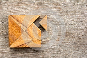 Tangram puzzle with one piece is wait to match the square shape