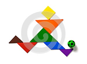 Tangram shaped as a player dribbling a soccer on white background