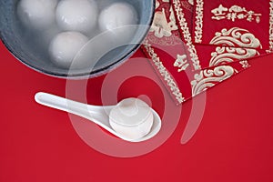 Tangyuan and hongbao in the background of red Festival. The Chinese characters in the picture mean `happiness`