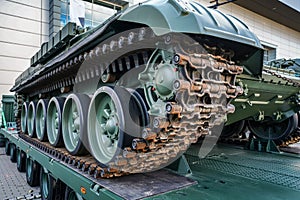 Tank armoured vehicle loaded on truck, detail to continuous tread tracks