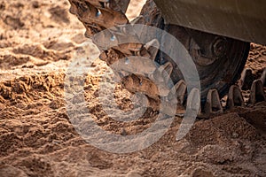 Tank caterpillars in the sand, close up shot