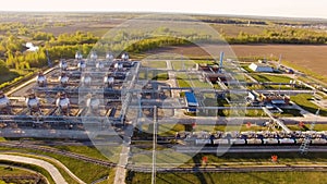 Tank farm for bulk petroleum and gasoline storage next to rail line. Aerial view