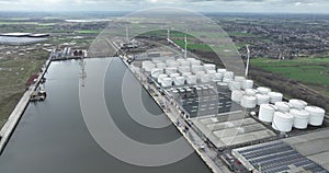 Tank storage containers and silos at the Ghent Tank terminal, a small port along the water. The Ghent Terneuzen canal