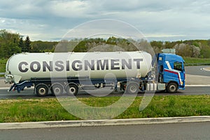 On a tank truck driving along the road there is an inscription - consignment