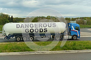On a tank truck driving along the road there is an inscription - dangerous goods