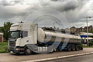 Tank truck parked on by the road