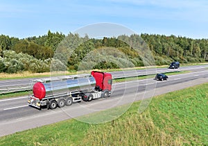 Tank truck transport of liquid, foodstuff. Metal chrome cistern tanker for food transportation on highway. Out of focus, possible